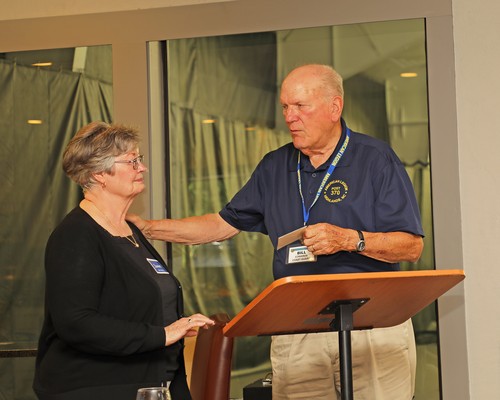 Post 370 Legionnaire Bill Edwards presents Janet McCloskey a gift card to Wolfgang's Restaurant and Wine Bistro.